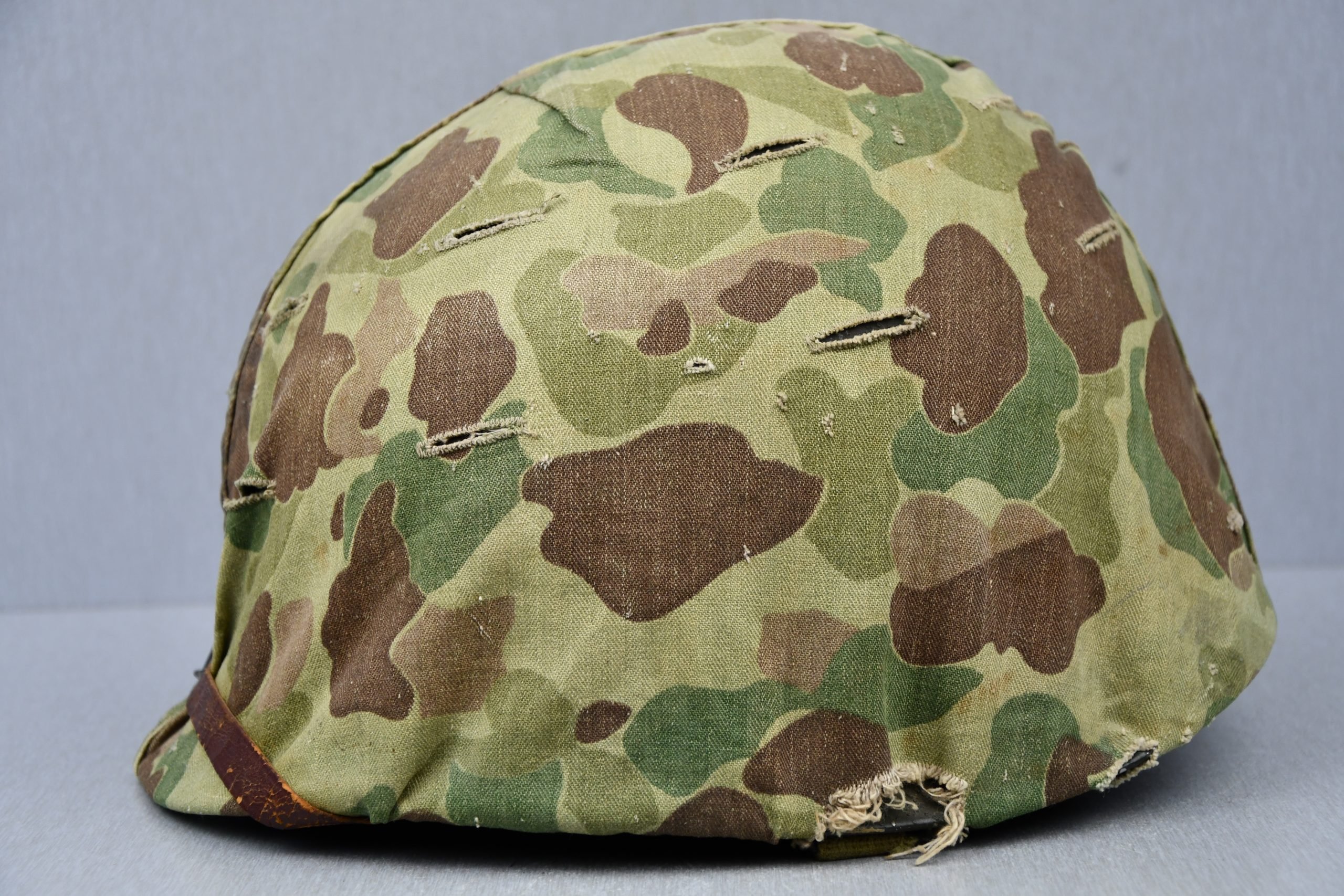 US WW2 M1 steel fixed bail helmet with liner by 'Int'l Molded Plastics Co' and USMC camo cover — image 4
