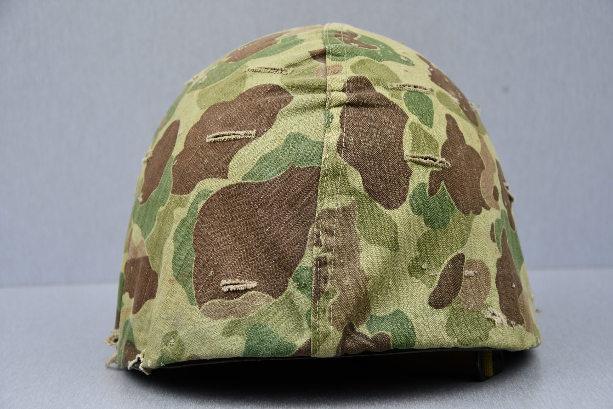 US WW2 M1 steel fixed bail helmet with liner by 'Int'l Molded Plastics Co' and USMC camo cover — image 5