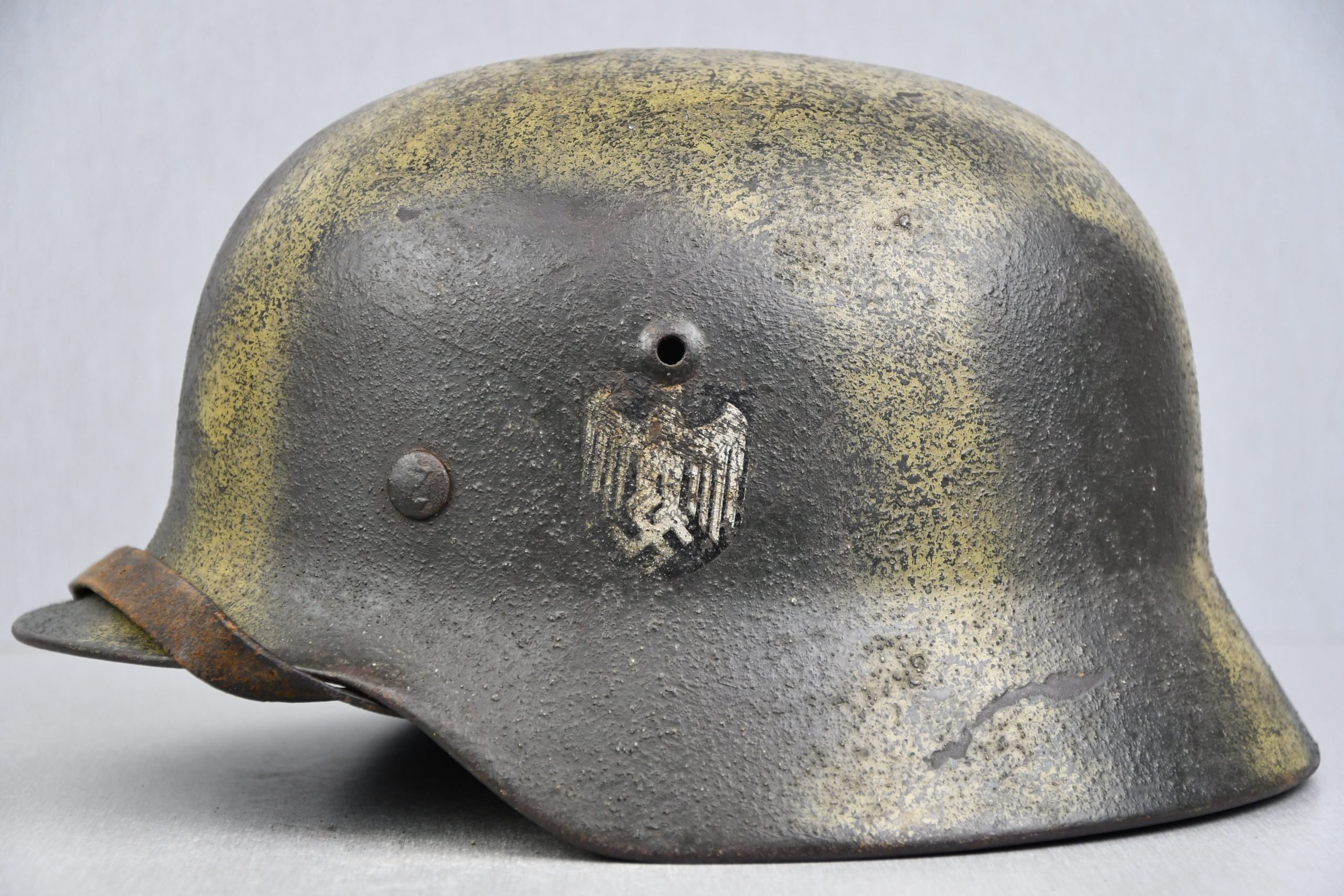 M35 army (Heer) reissued single decal camouflage steel helmet with bullet hit
