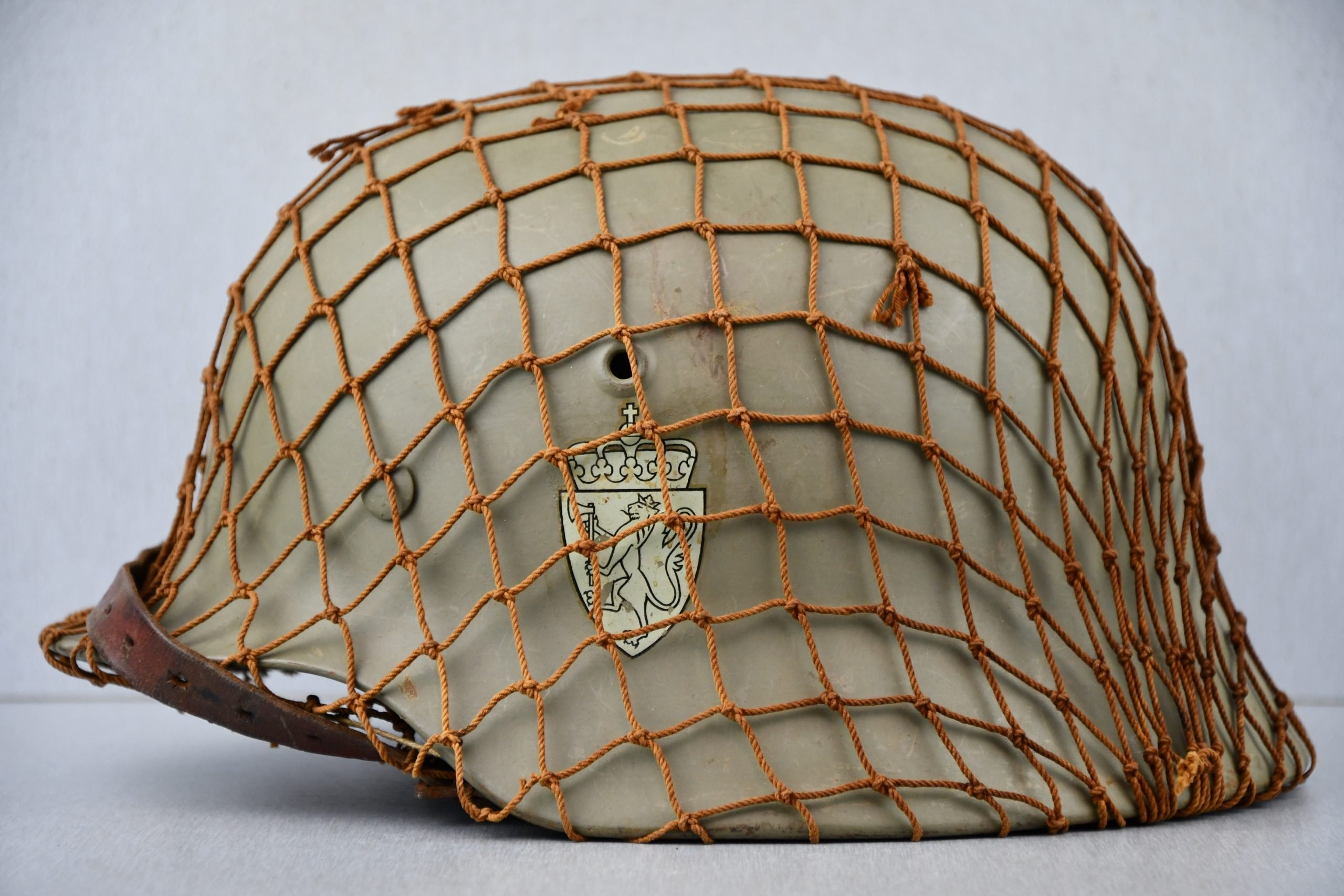 M40 Norwegian reissued steel helmet ET64 with camouflage net — image 3