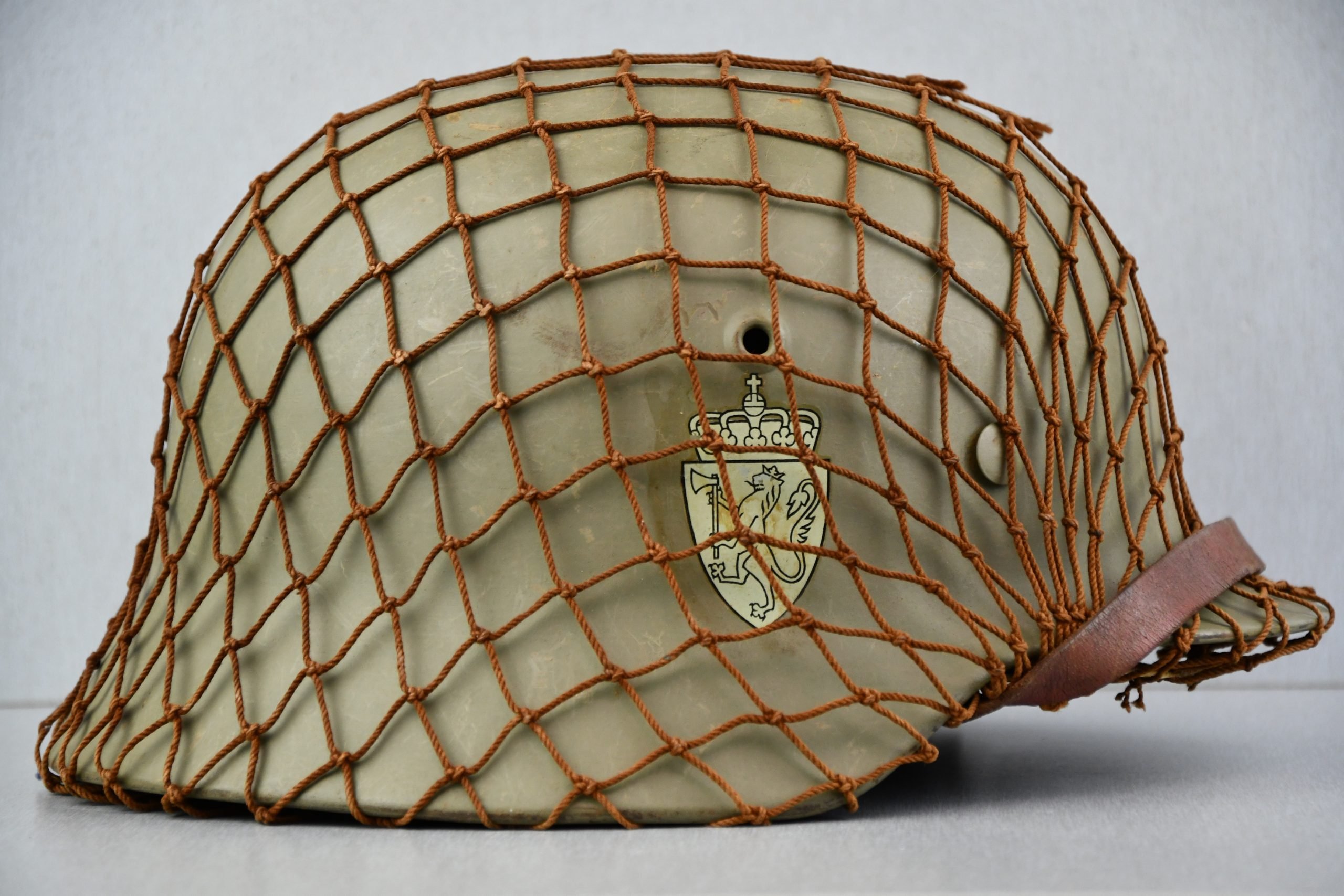 M40 Norwegian reissued steel helmet ET64 with camouflage net — image 5