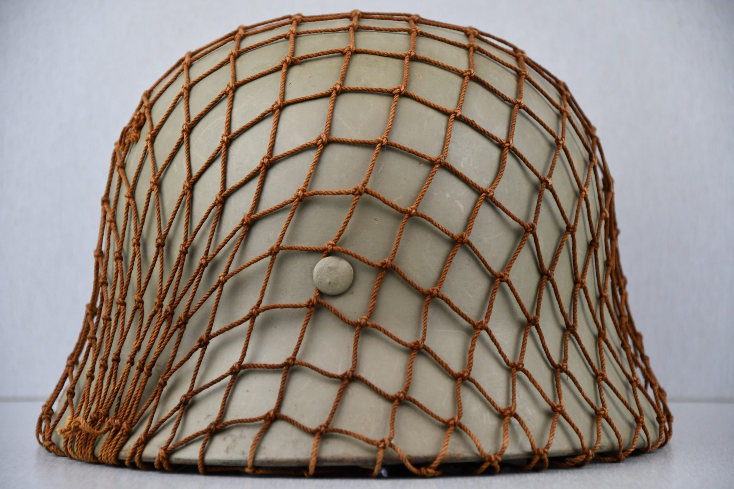 M40 Norwegian reissued steel helmet ET64 with camouflage net — image 6