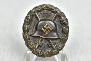 First pattern black wound badge