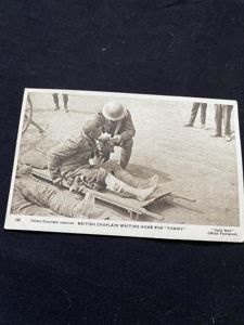BRITISH CHAPLAIN WRITING HOME FOR 'TOMMY' POSTCARD