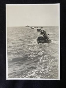 PHOTO OF SMALL BOATS BEING TOWED BY A U-BOAT