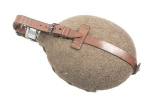 M31 canteen marked WWE 37 with brown straps and roller …