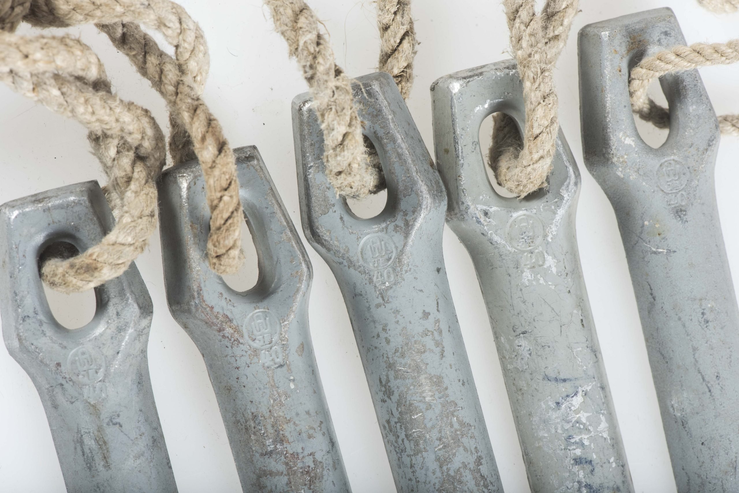 Four matching Zeltbahn pegs marked AW JE 40 — image 2