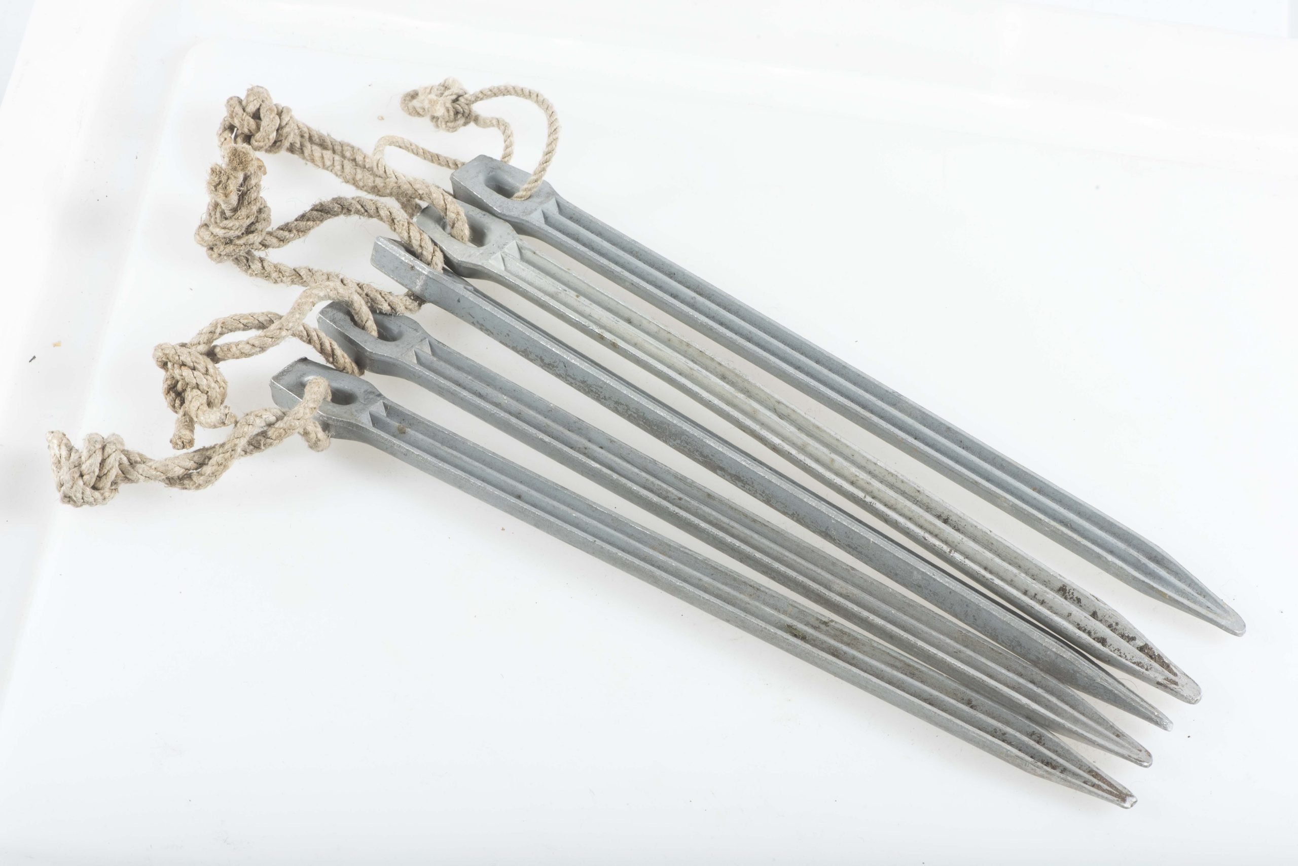 Four matching Zeltbahn pegs marked AW JE 40 — image 4