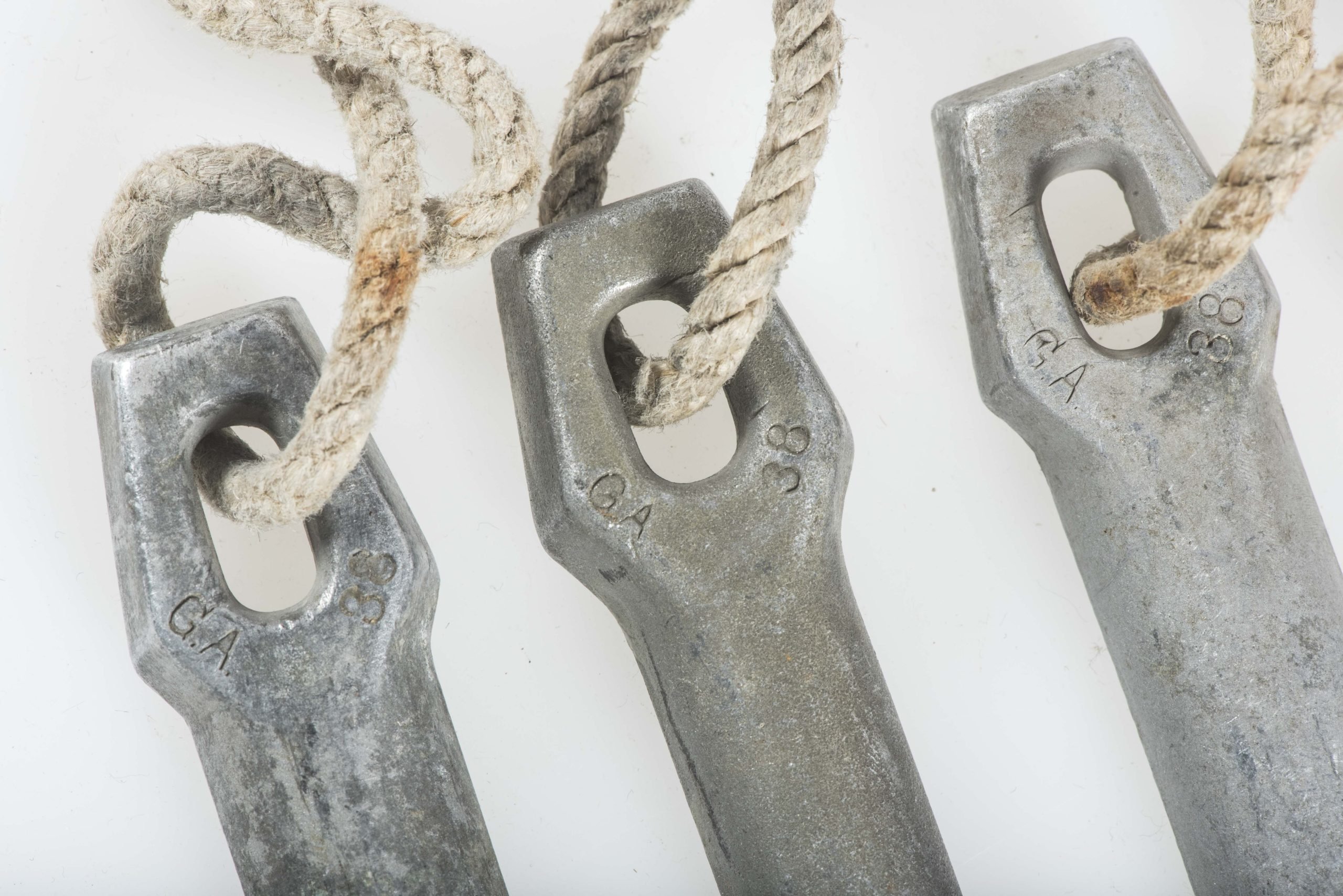 Three matching Zeltbahn pegs marked GA 38 — image 2