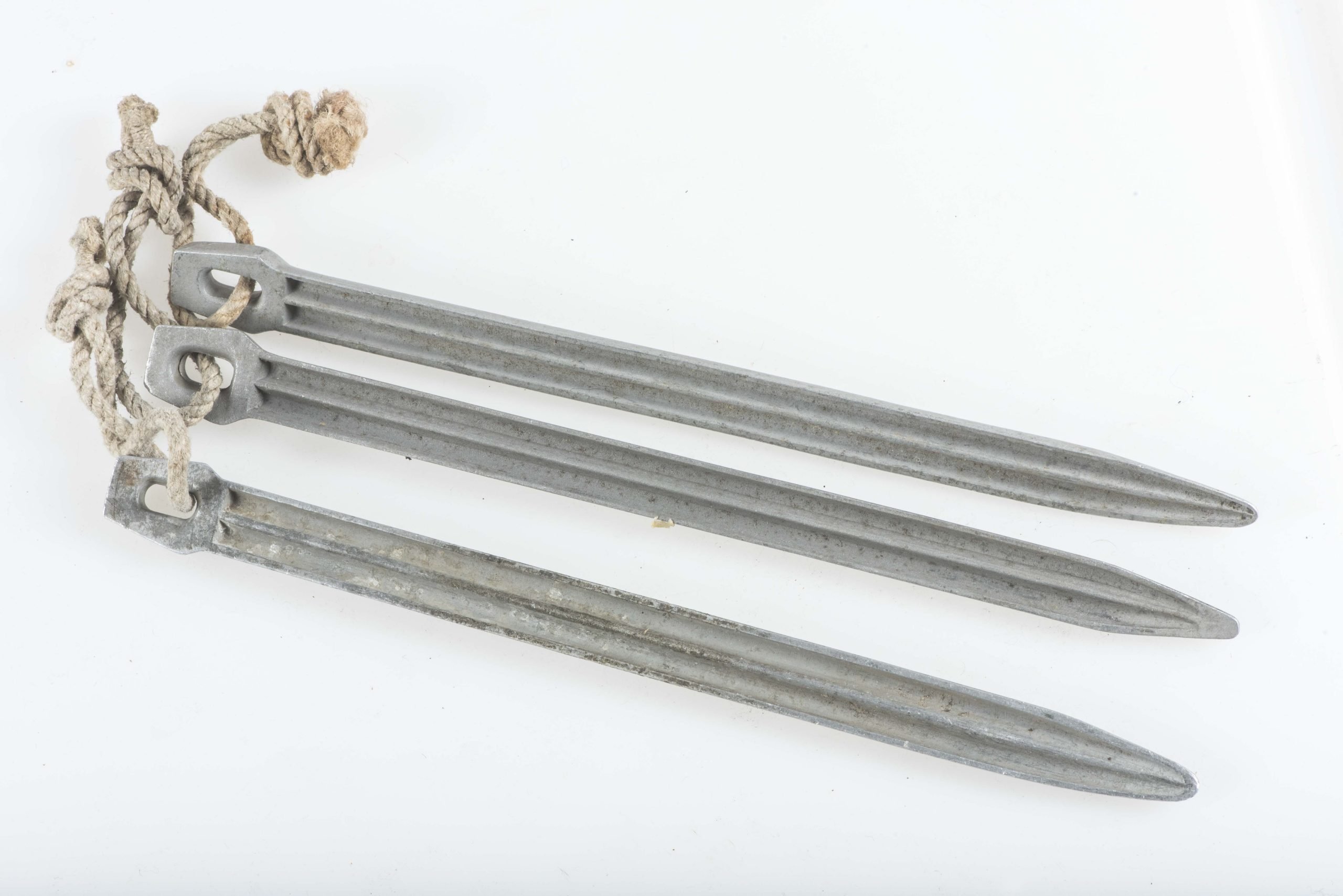 Three matching Zeltbahn pegs marked GA 38 — image 3