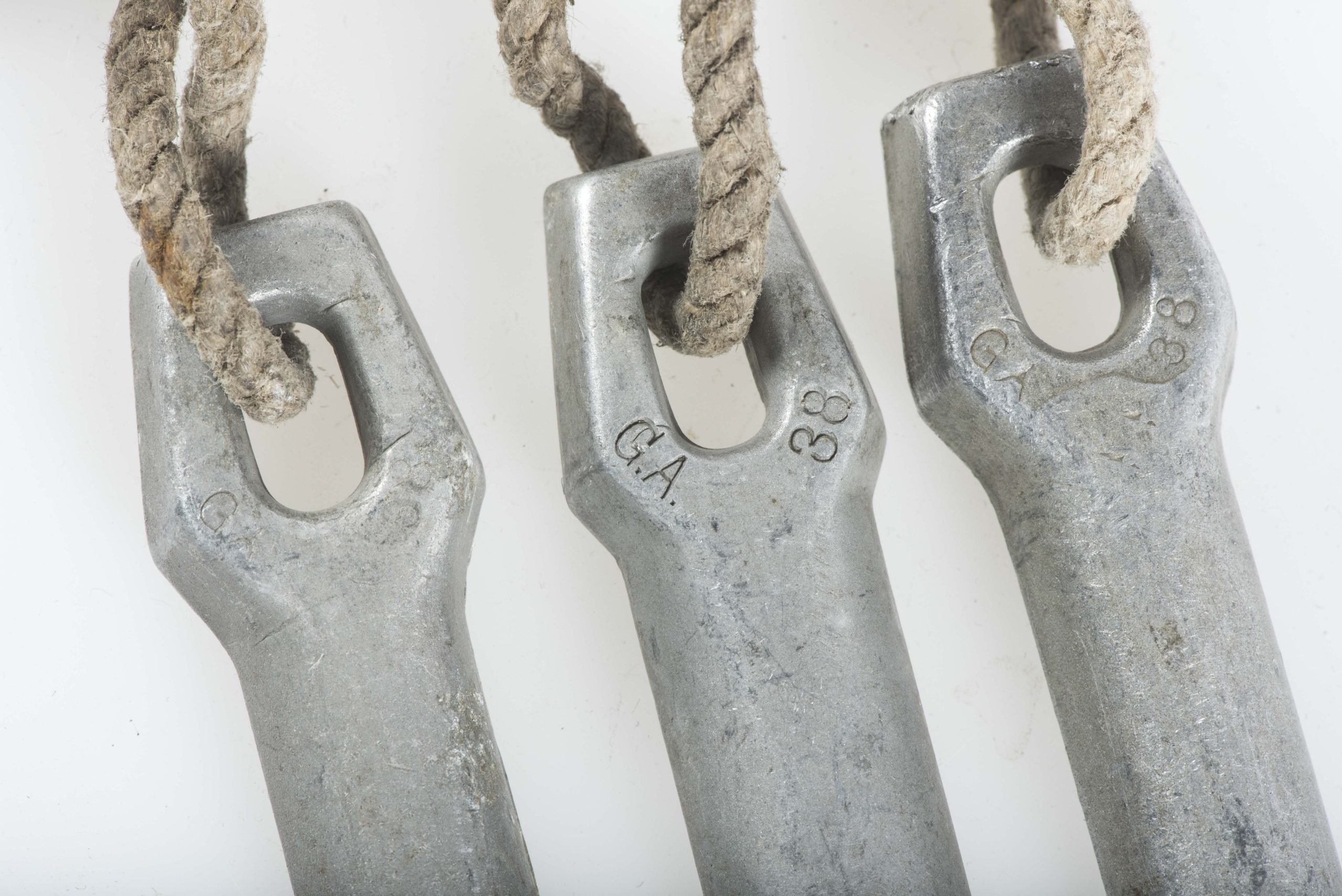 Three matching Zeltbahn pegs marked GA 38 — image 2