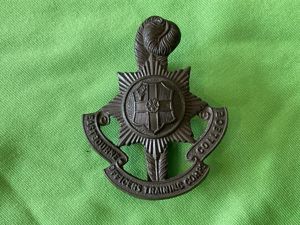 Eastbourne College O.T.C dark bronze finished cap badge