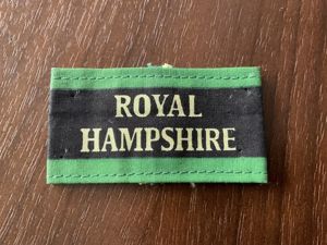 ROYAL HAMPSHIRE Regt Malaya era printed cloth slip on title.