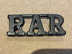 Rhodesian African Rifles (R.A.R) blackened brass title.