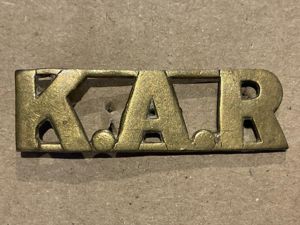 K.A.R (Kings African Rifles) brass shoulder title.