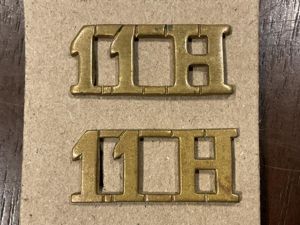 WW1 11th Hussars Brass shoulder titles.