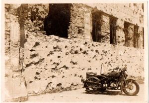 Photograph of a Japanese Navy Motorcycle at Battle Damaged Building …