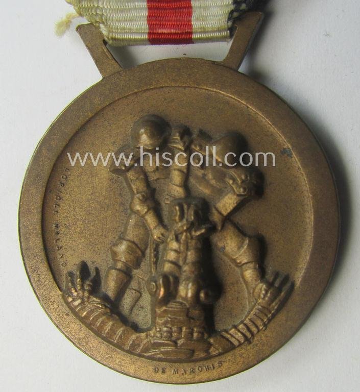Golden-bronze-coloured- (and I deem 'Buntmetall'-based-) example of a: 'Deutsch-Italienische Feldzugsmedaille' (or: German-Italian campaign-medal) that comes mounted onto its (regular-sized) piece of original (and minimally faded!) ribbon — image 2