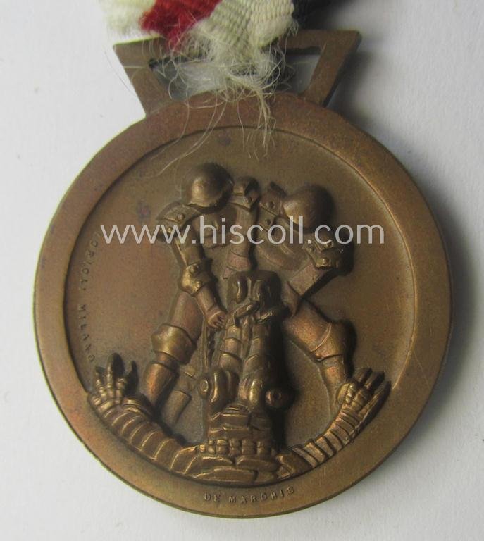 Golden-bronze-coloured- (and I deem 'Buntmetall'-based-) example of a: 'Deutsch-Italienische Feldzugsmedaille' (or: German-Italian campaign-medal) that comes mounted onto its (regular-sized) piece of original (and sun-faded!) ribbon — image 2