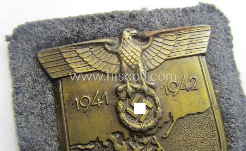 WH (Luftwaffe) 'Krim'-campaign-shield that comes mounted onto its original, bluish-grey-coloured 'backing' and that comes in a surely issued-, minimally worn and/or (I deem) carefully tunic-removed-, condition — image 2