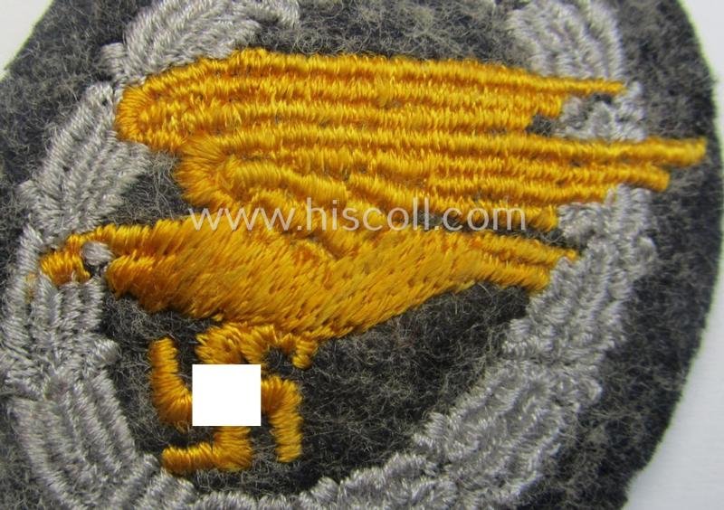WH (Luftwaffe) 'Fallschirmschützen-Abzeichen in Stoff' (or: cloth-based paratroopers' jump-badge) that is nicely machine-embroidered and being of the so-called: 'padded version' — image 2