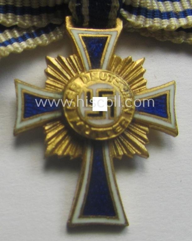 Miniature of an: 'Ehrenkreuz der deutschen Mutter - erste Stufe' (or: golden-class mothers'-cross) being a non-maker-marked example that comes in an overall nice- (albeit moderately worn- ie. used-), condition — image 2