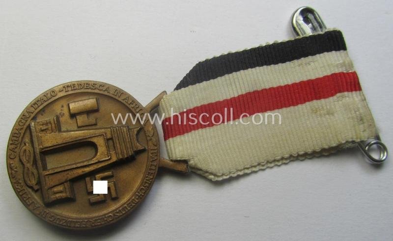 Golden-bronze-coloured- (and I deem 'Buntmetall'-based-) example of a: 'Deutsch-Italienische Feldzugsmedaille' (or: German-Italian campaign-medal) that comes mounted onto its (regular-sized) piece of original (and somewhat faded!) ribbon — image 3