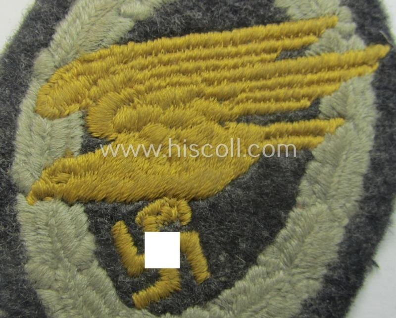 WH (Luftwaffe) 'Fallschirmschützen-Abzeichen in Stoff' (or: cloth-based paratroopers'-jump-badge) being a nicely machine-embroidered specimen that comes in a just moderately used- ie. carefully tunic-removed, condition — image 3