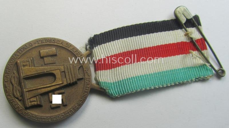 Golden-bronze-coloured- (and I deem 'Buntmetall'-based-) example of a: 'Deutsch-Italienische Feldzugsmedaille' (or: German-Italian campaign-medal) that comes mounted onto its (regular-sized) piece of original (and hardly faded!) ribbon — image 3