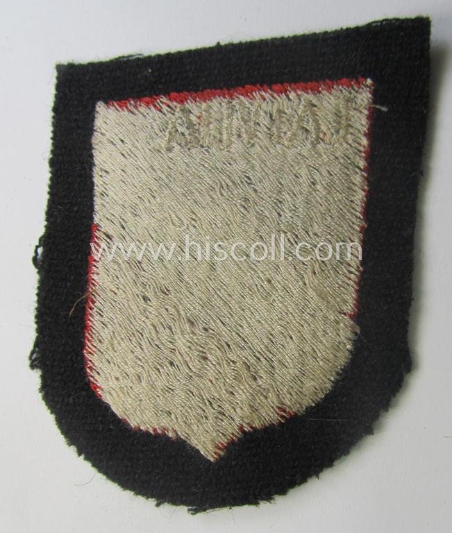 Waffen-SS 'volunteer'-arm-shield as was intended for usage by soldiers of the: '15. o. 19. Waffen-Grenadier-Division der SS' (ie. 'lettische nr. 1 o. 2') and that comes in a 'virtually mint- ie. unissued', condition — image 2