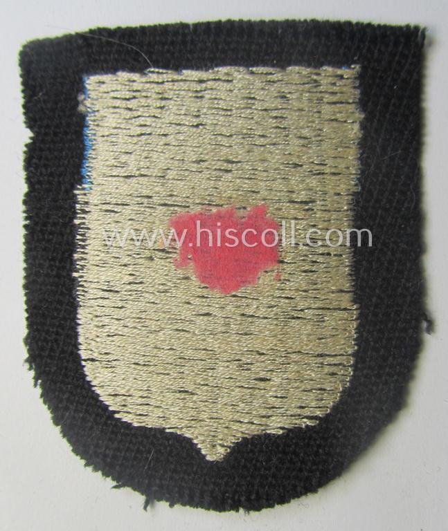 Waffen-SS 'volunteer'-arm-shield as was intended for usage by soldiers of the: '20. Waffen-Grenadier-Division der SS' (ie. 'estnische Nr. 1') and that comes in a 'virtually mint- ie. unissued', condition — image 2