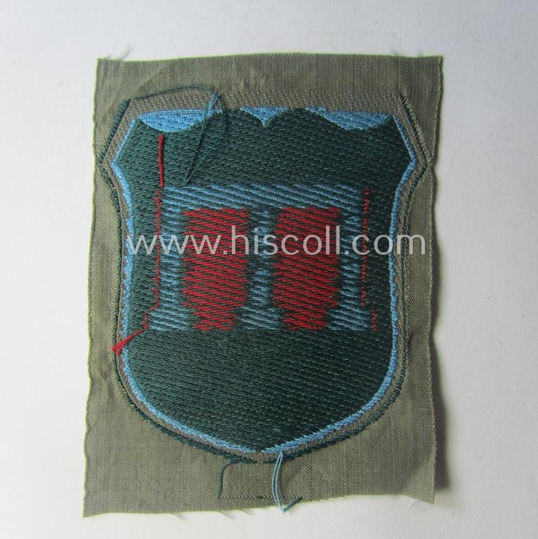 Eastern- (ie. Russian-) volunteer related armshield as executed in 'BeVo'-weave pattern depicting a red-coloured 'Tamga'-symbol as was intended for a volunteer who served within the 'Deutsche Wehrmacht' (ie. within the 'Crimean-Tartar Legion') — image 2