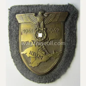 WH (Luftwaffe) 'Krim'-campaign-shield that comes mounted onto its original, bluish-grey-coloured …