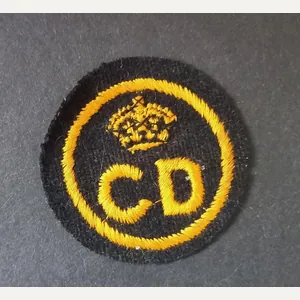 A nice British CD (Civil Defence) un-issued beret badge