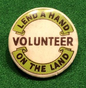Lend a Hand on the Land lapel badge.