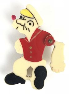Popeye the Sailor cartoon character badge with articulating arm