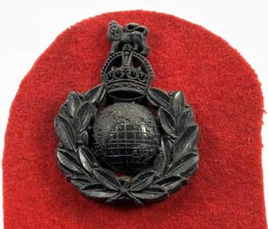 WW2 Royal Marines plastic economy issue badge on red felt …