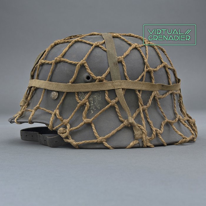 RH29 Heer M40 single decal camouflaged helmet with issue net and elastic bands — image 2