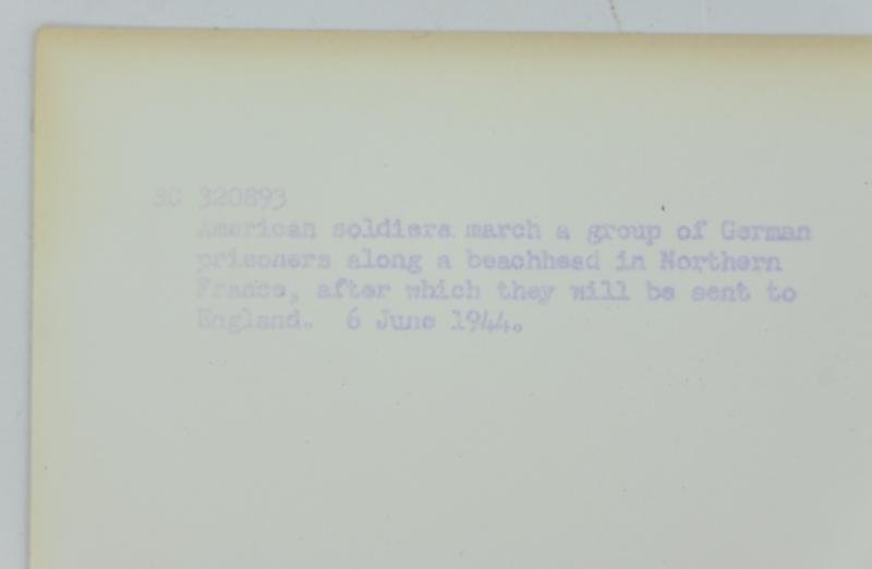 US WW2 Press Photo 'Prisoners of War on the Normandy Beach' — image 7