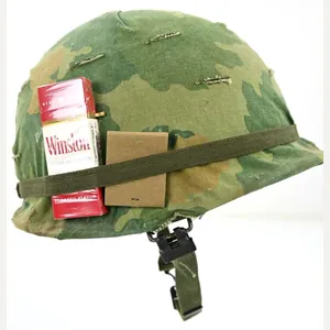 US Vietnam War Infantry helmet with camouflage cover and attached …