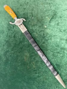 MOST UNUSUAL SHOOTING ASSOCIATION DAGGER/CUTLASS WITH ORANGE CELLULOID GRIP.